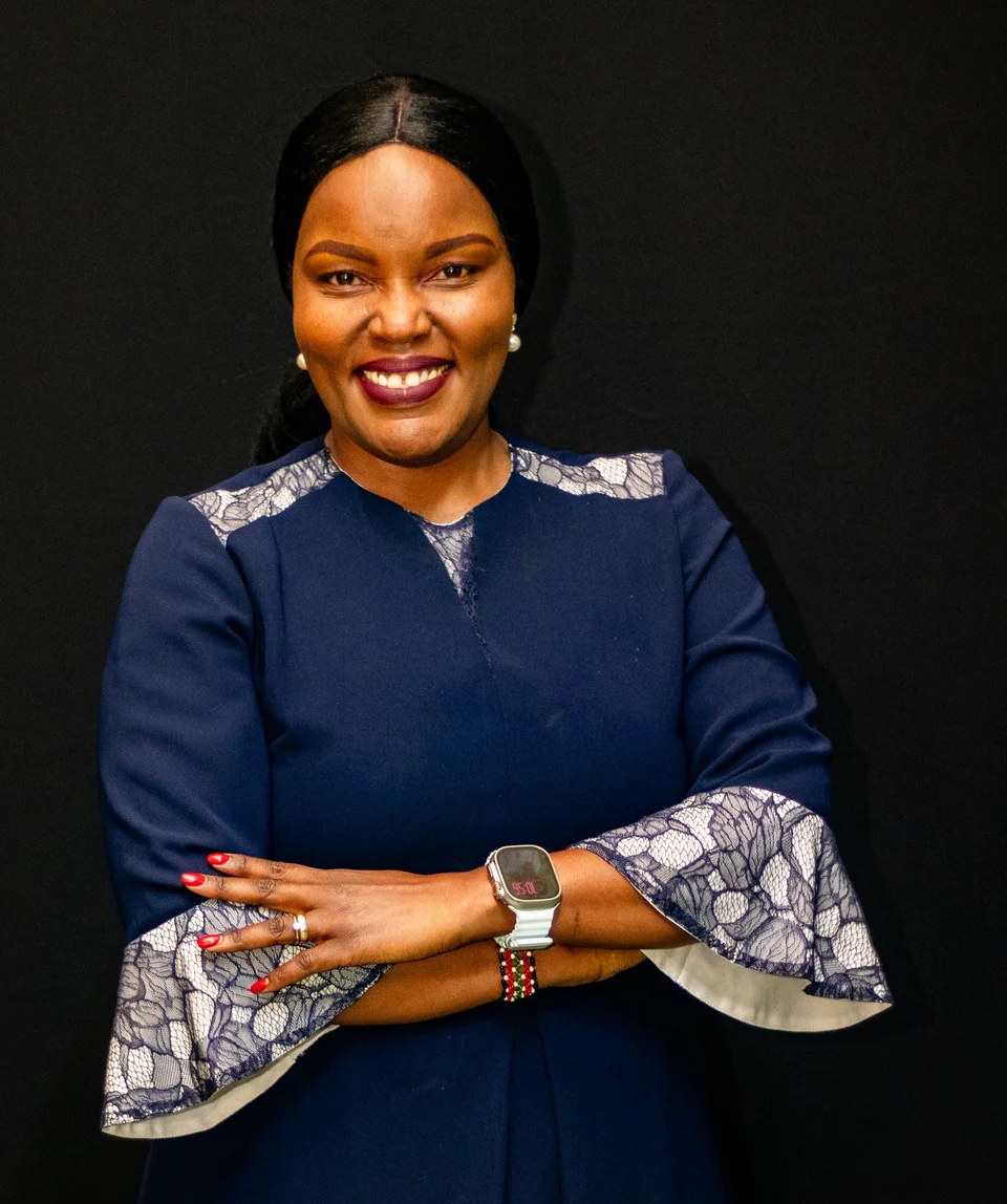 Rev. Dr. Joyce Kariuki in a navy outfit with floral cuffs